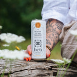 Person holding a Heti CBD & THC mocktail beverage can in flavor Meadow Cat Nap which is dandelion leaf, lemon balm and wild mint