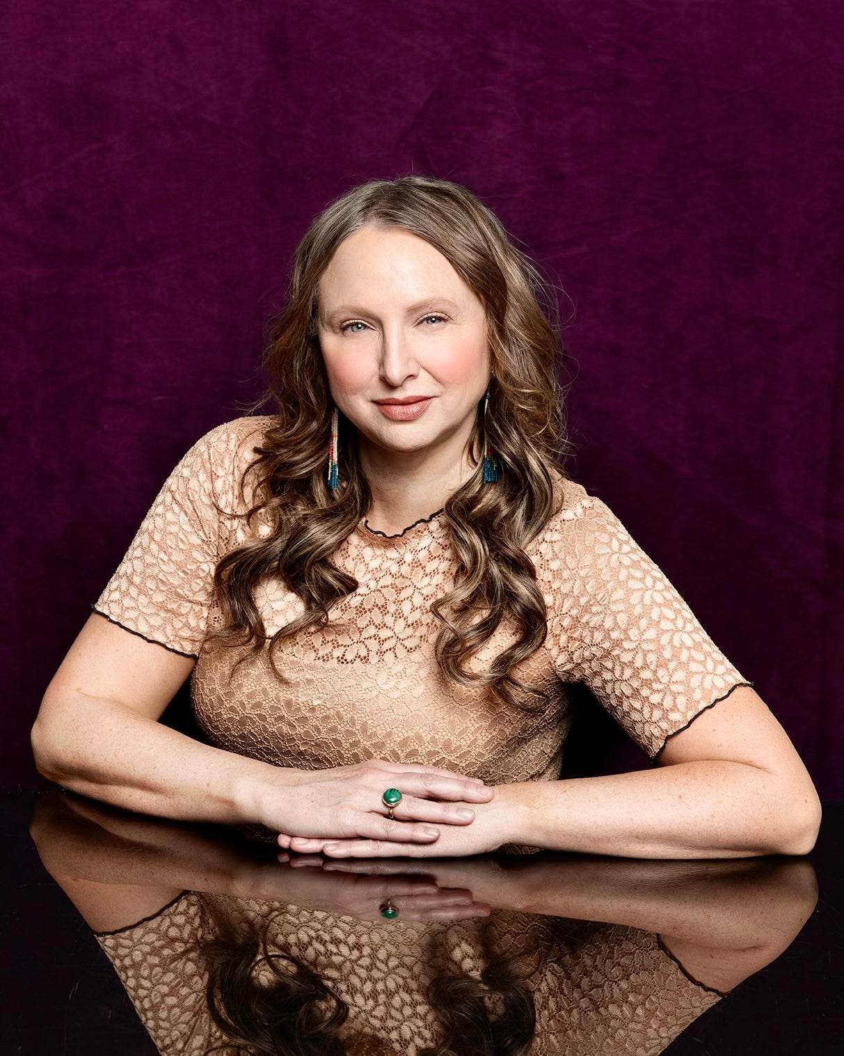 Heti founder and CEO, Dana Thompson portrait. Dana is a James Beard award winning restaurateur, social impact entrepreneur and visionary. She is wearing a pink shirt with a purple background in this image. Photo credit Shelly Mosman photography
