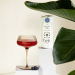 River Path low-dose THC and CBD drink by Heti with blueberry and rosehip, served as a mocktail with fresh blueberries.