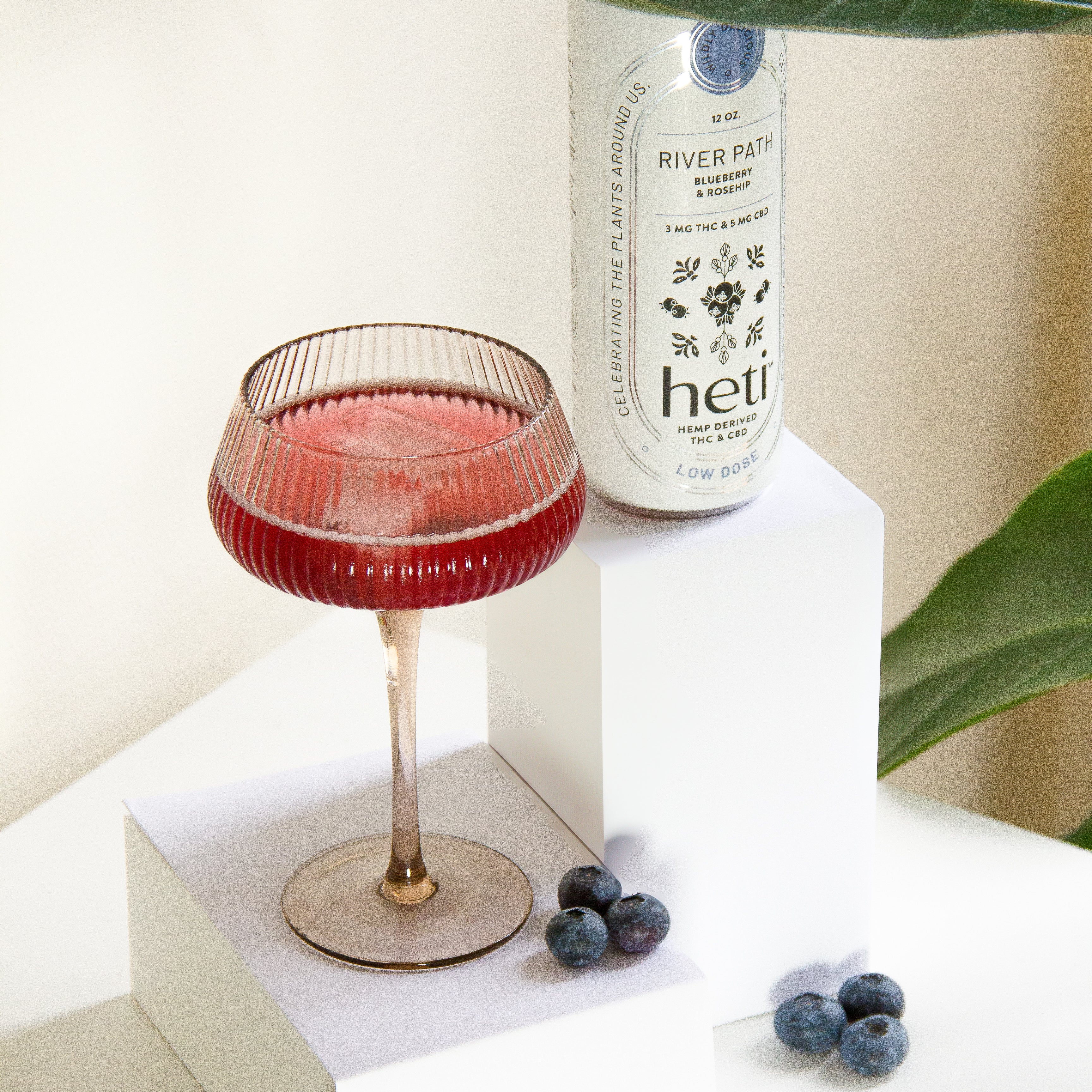 River Path low-dose THC and CBD drink by Heti with blueberry and rosehip, served as a mocktail with fresh blueberries.